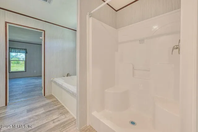 a bathroom with a bathtub and shower