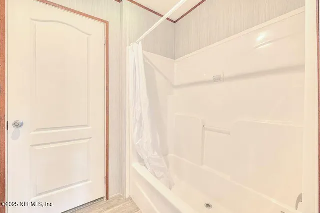 a bathroom with a bathtub and a shower