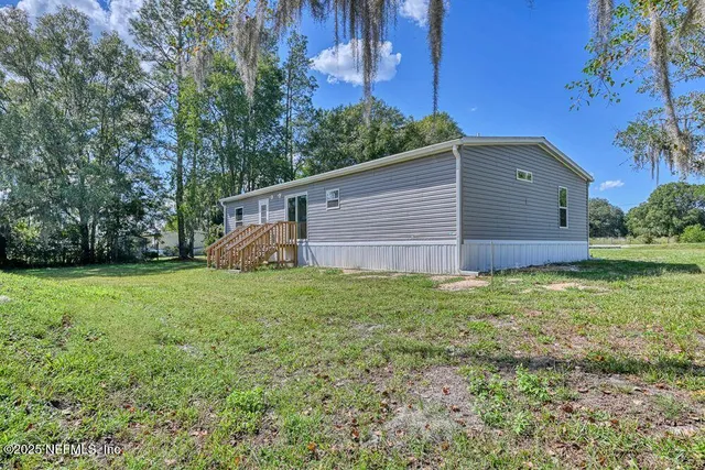a backyard of a house with lots of green space