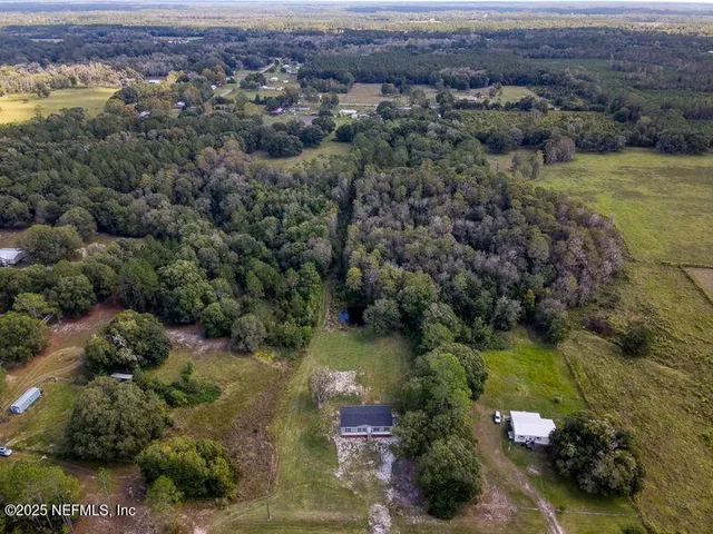 an aerial view of a houses with a yard