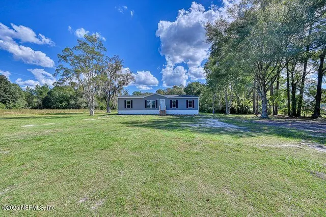 a view of a house with a big yard