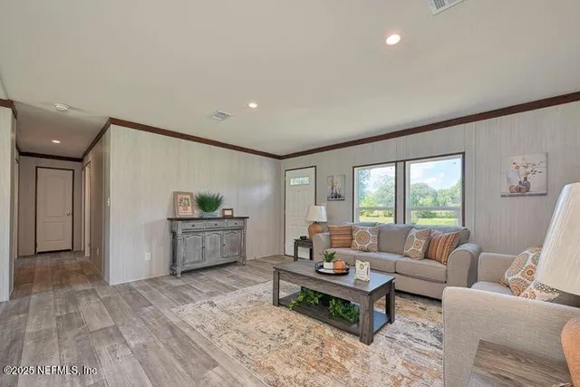 a living room with furniture and a wooden floor