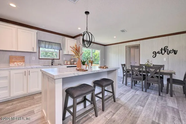 a kitchen with sink cabinets and dining table