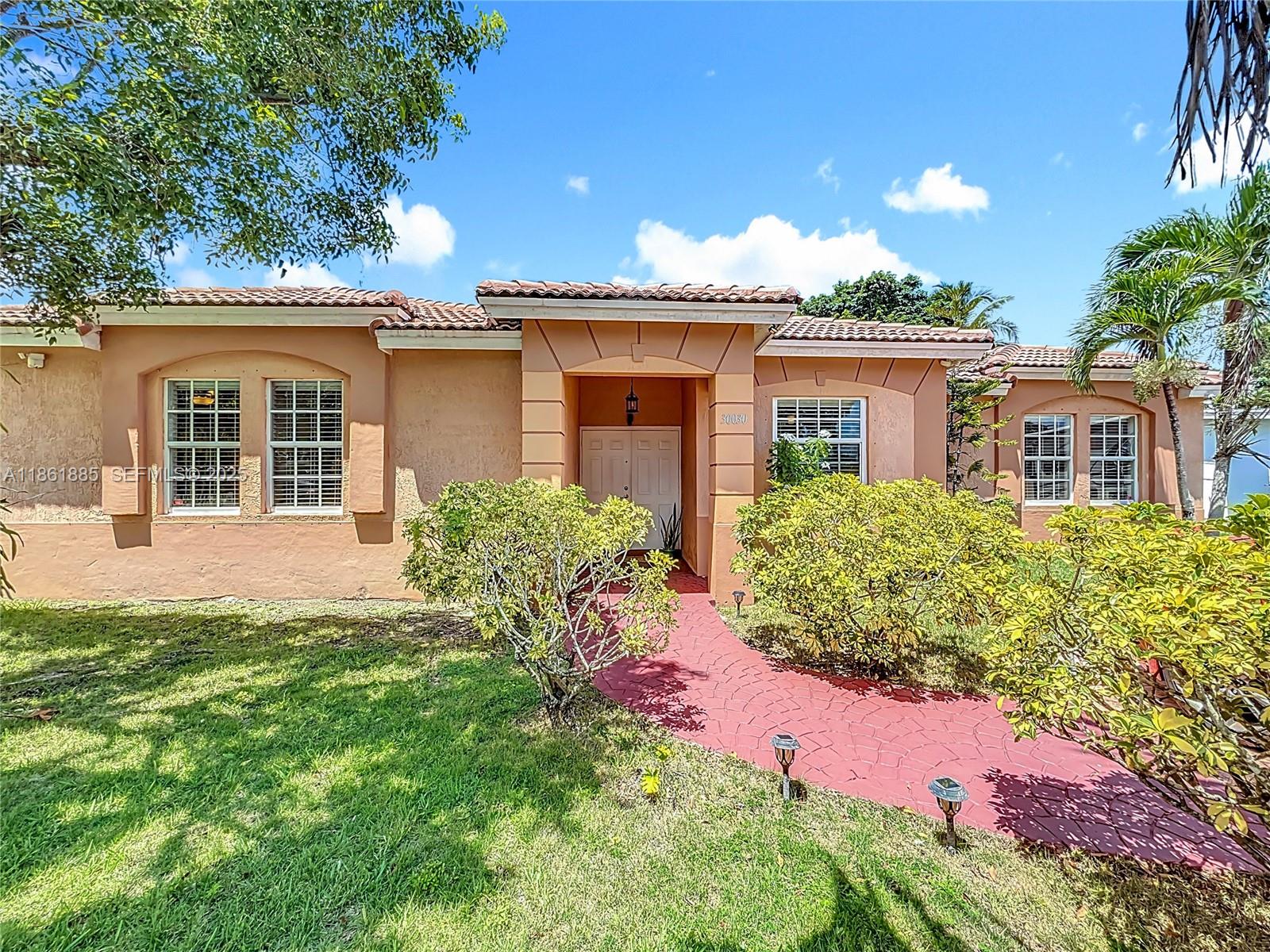 30030 Southwest 154th Avenue Homestead, FL 33033 - Photo 1 of 70 front view of a house with a yard
