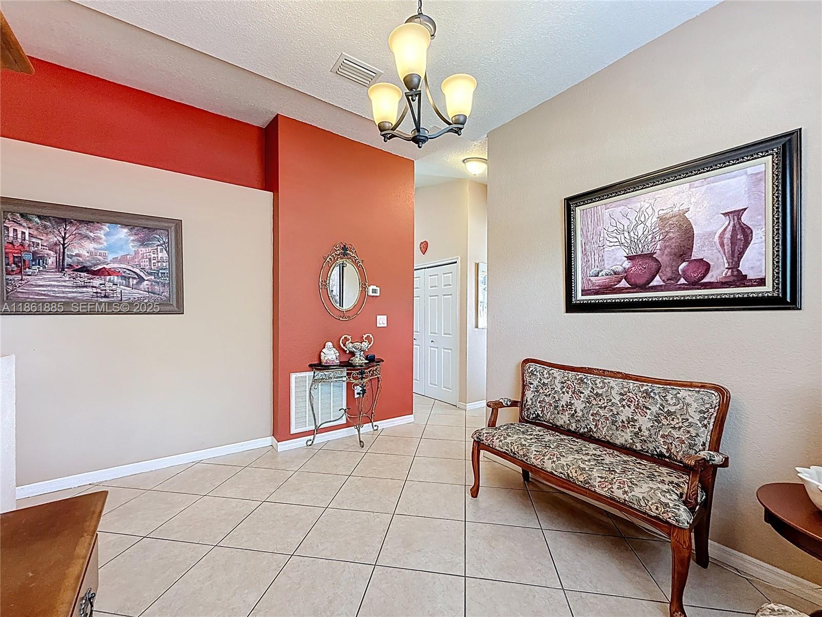 30030 Southwest 154th Avenue Homestead, FL 33033 - Photo 17 of 70 a living room with furniture and a chandelier