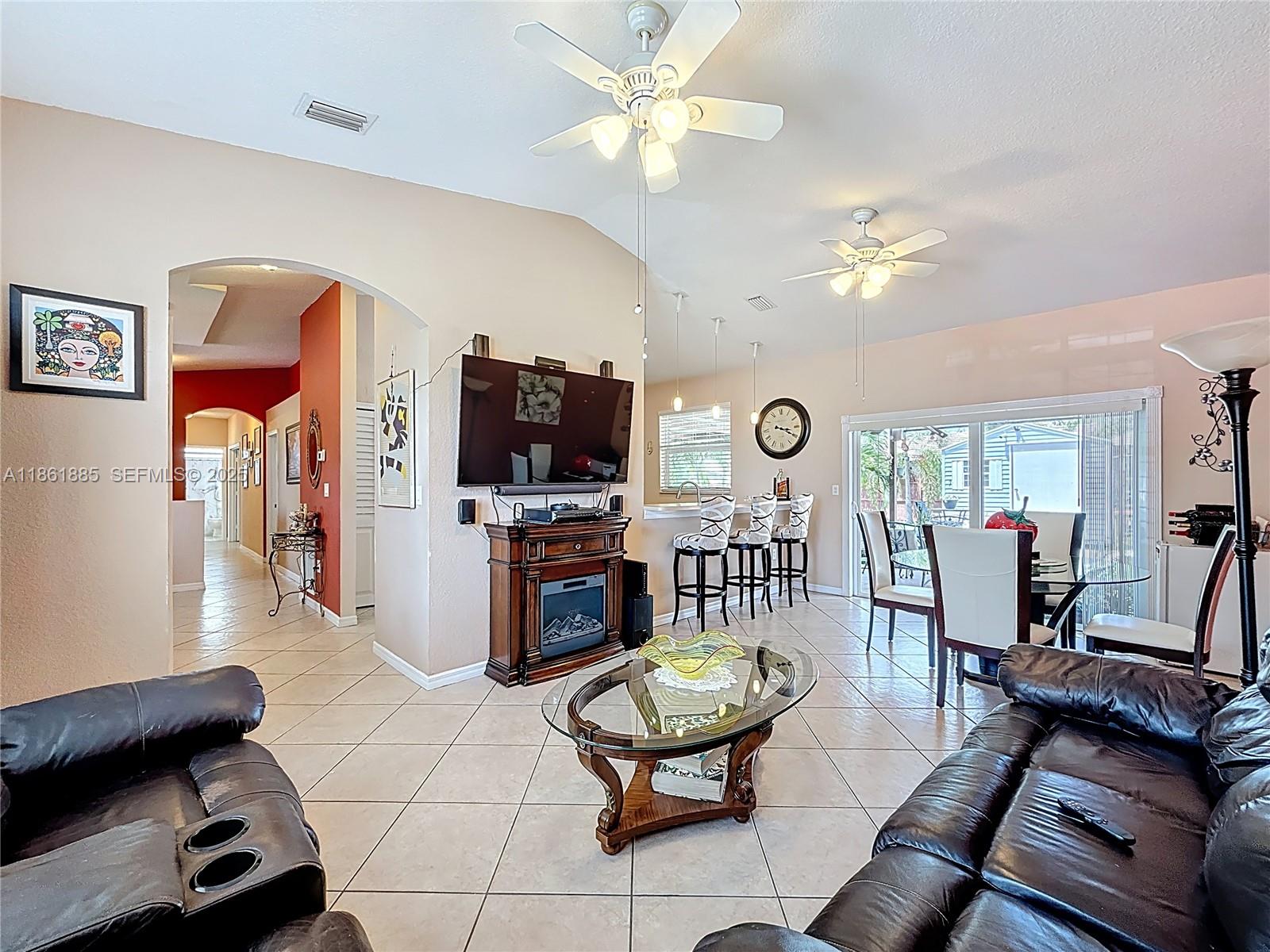 30030 Southwest 154th Avenue Homestead, FL 33033 - Photo 19 of 70 a living room with furniture a flat screen tv and kitchen view