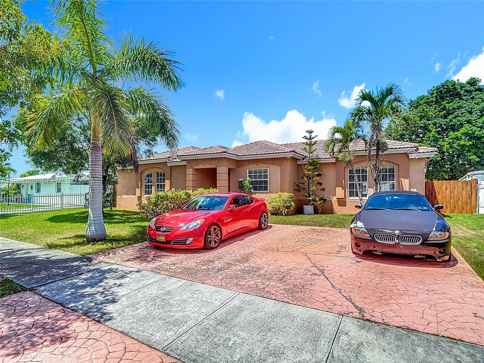 30030 Southwest 154th Avenue Homestead, FL 33033 - Photo 2 of 70 a front view of a house with garden
