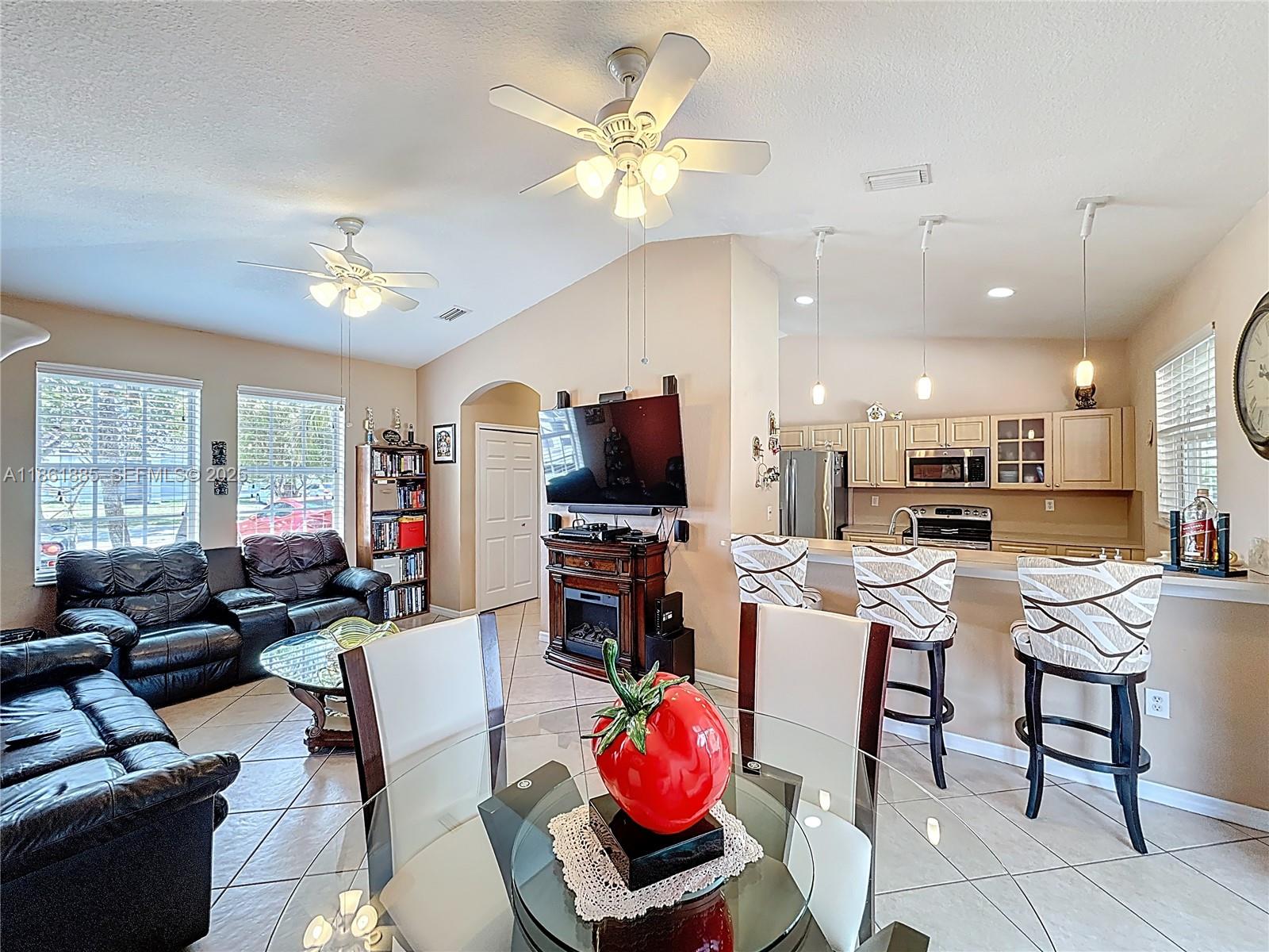 30030 Southwest 154th Avenue Homestead, FL 33033 - Photo 23 of 70 a living room with furniture a flat screen tv and kitchen view