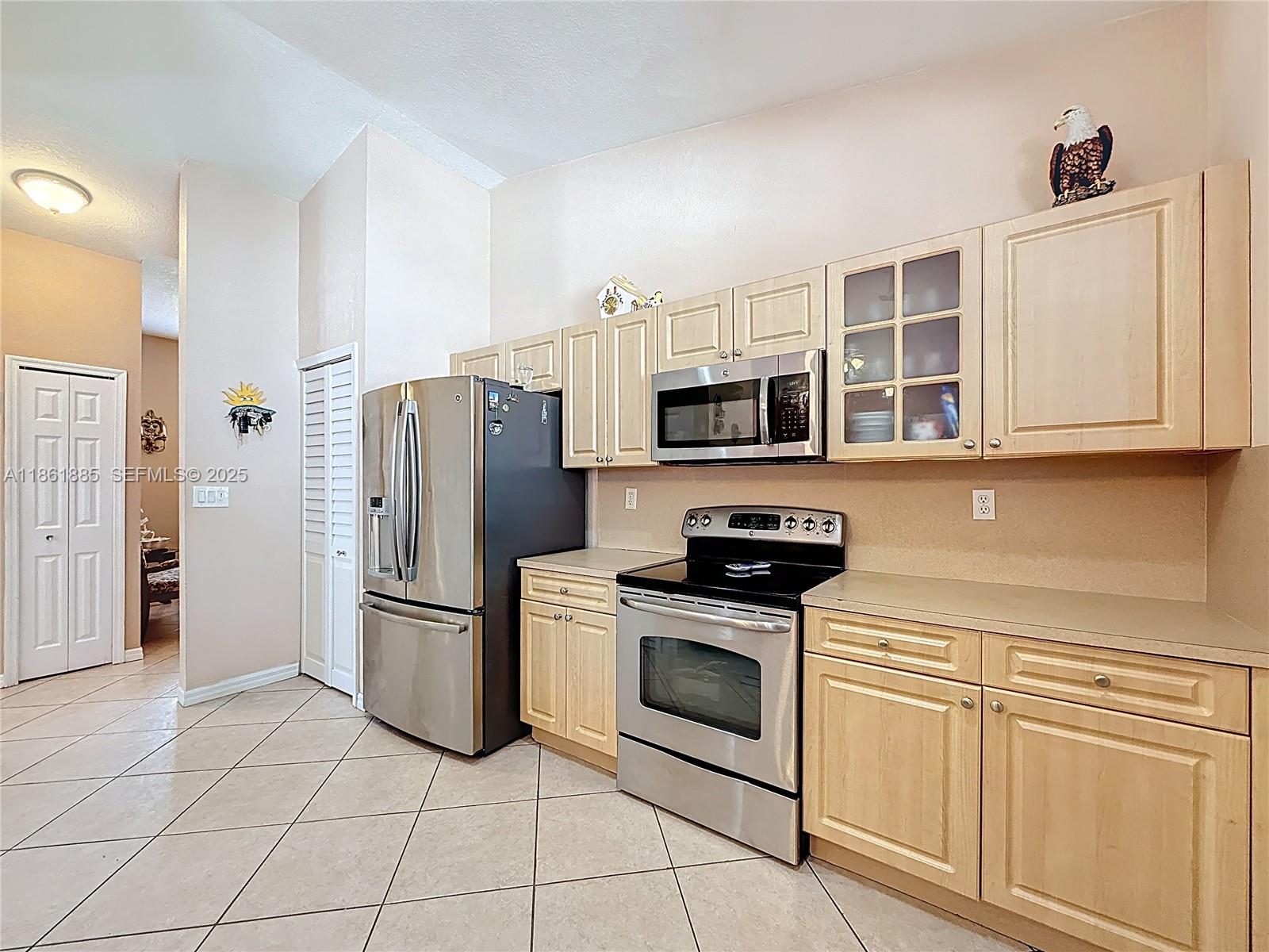 30030 Southwest 154th Avenue Homestead, FL 33033 - Photo 25 of 70 a kitchen with stainless steel appliances granite countertop a refrigerator and a stove top oven
