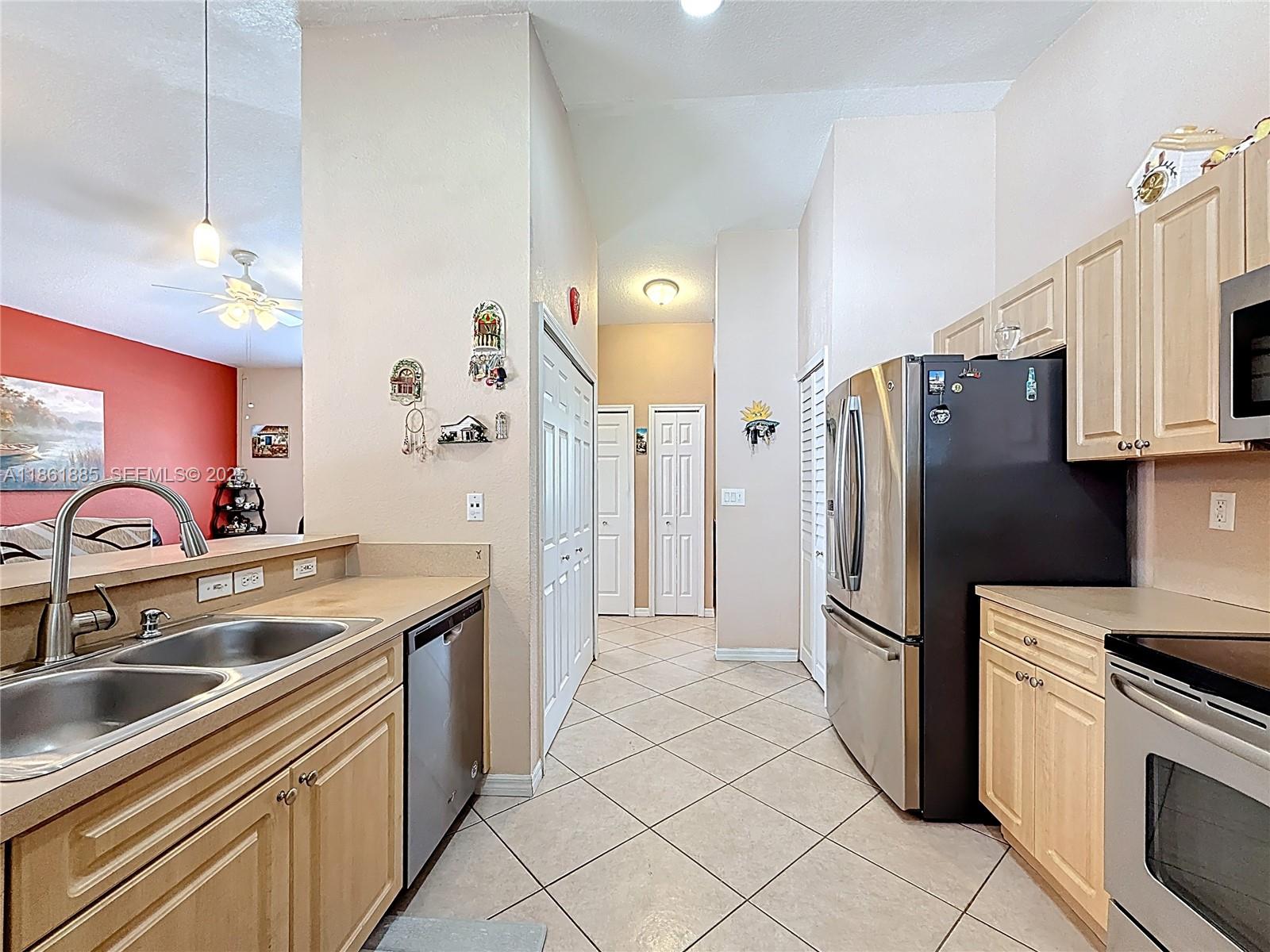 30030 Southwest 154th Avenue Homestead, FL 33033 - Photo 28 of 70 a kitchen with stainless steel appliances granite countertop a refrigerator sink and stove