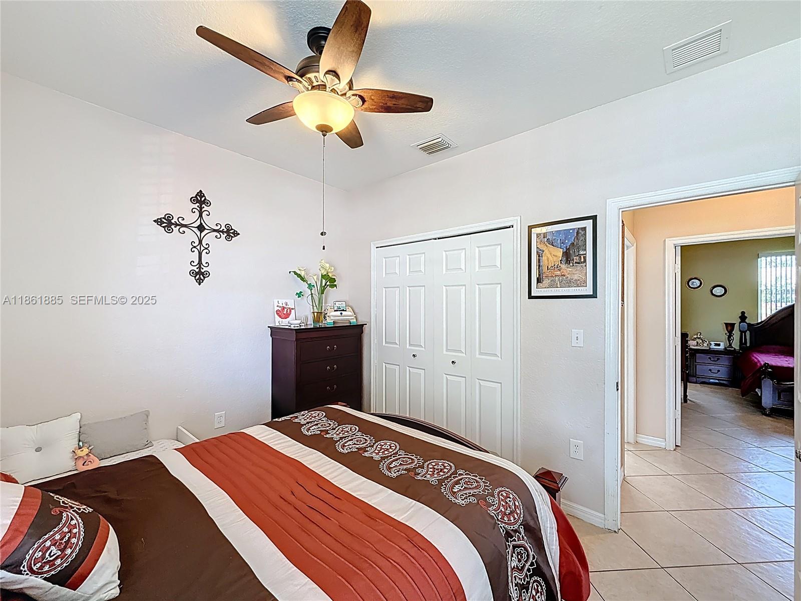 30030 Southwest 154th Avenue Homestead, FL 33033 - Photo 29 of 70 a bedroom with a bed and a chandelier
