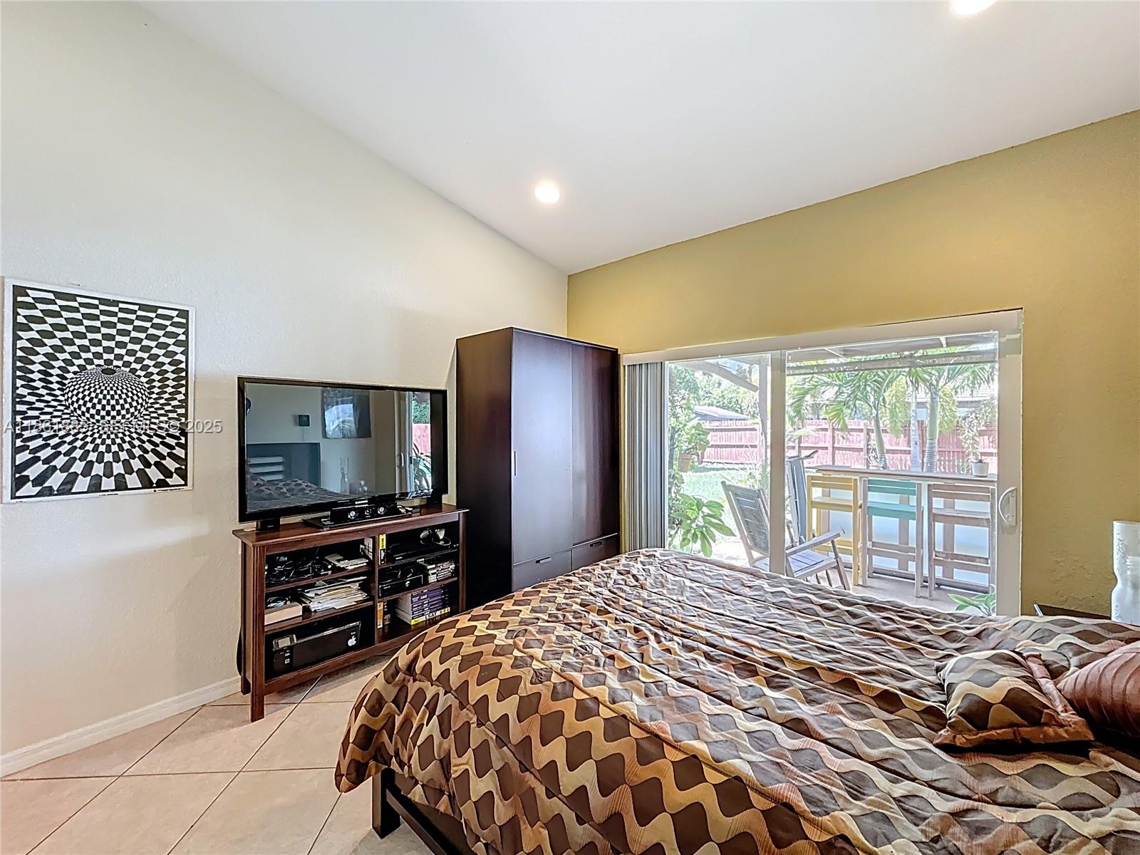 30030 Southwest 154th Avenue Homestead, FL 33033 - Photo 32 of 70 a bedroom with a bed and a flat screen tv