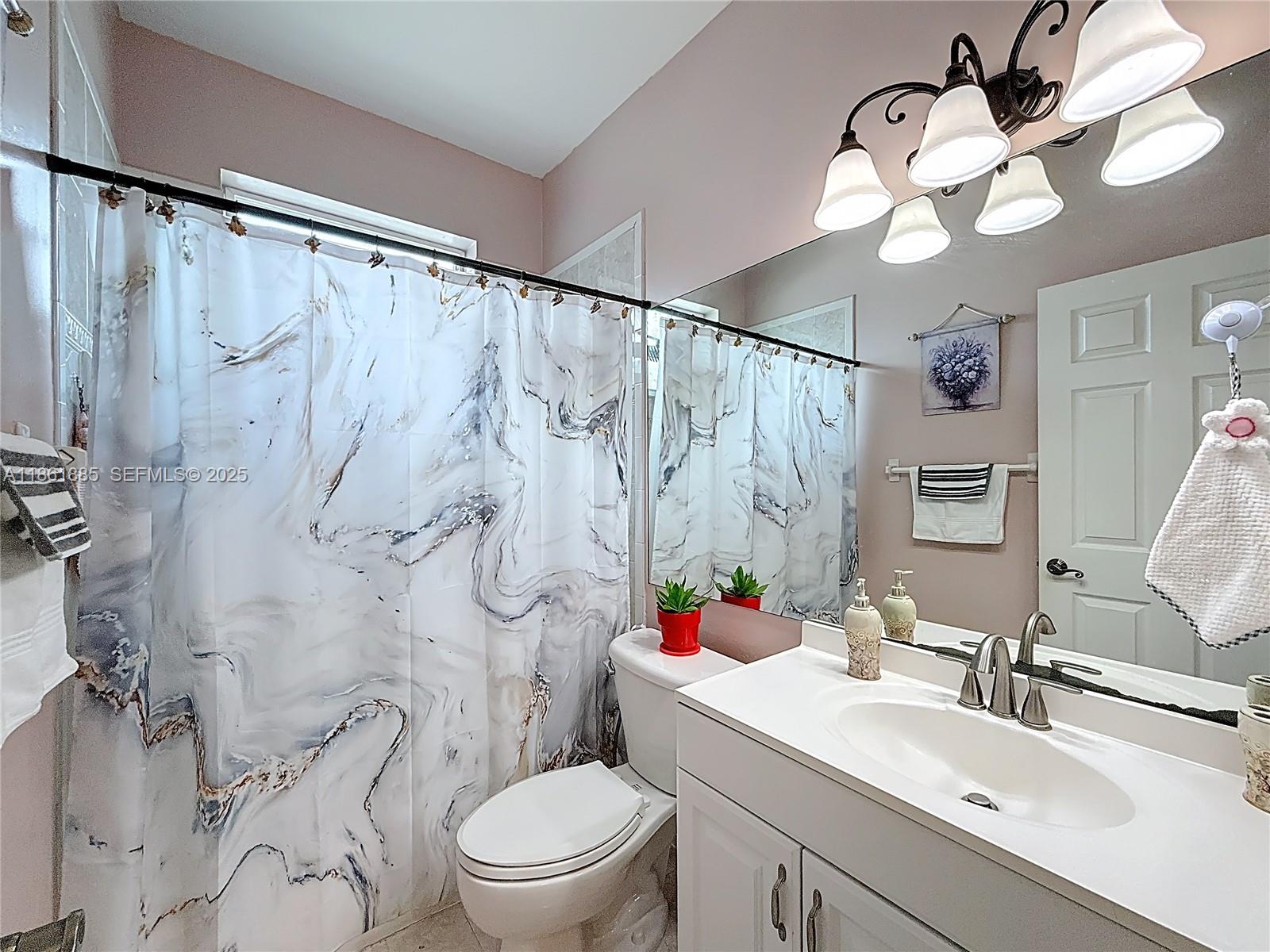 30030 Southwest 154th Avenue Homestead, FL 33033 - Photo 35 of 70 a bathroom with a sink vanity mirror and toilet