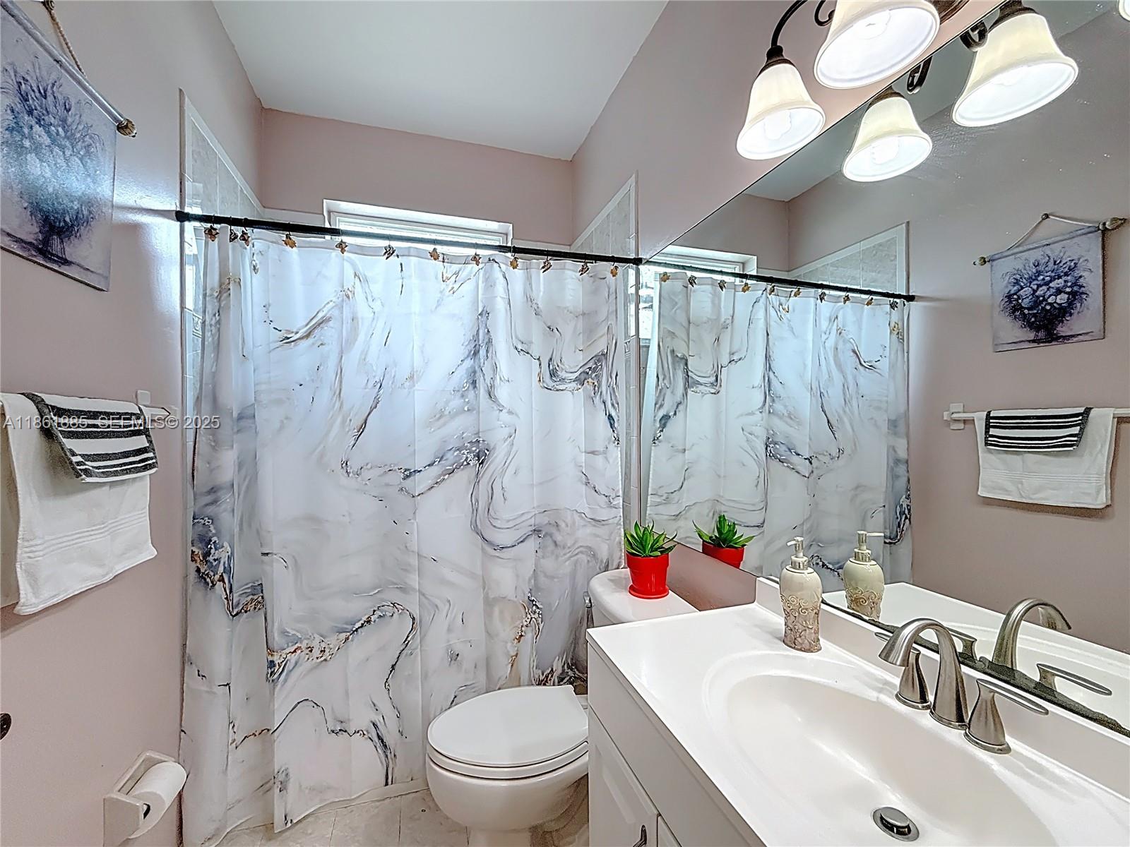 30030 Southwest 154th Avenue Homestead, FL 33033 - Photo 36 of 70 a bathroom with a sink vanity mirror and toilet