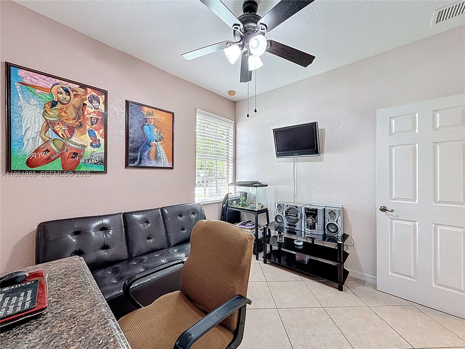 30030 Southwest 154th Avenue Homestead, FL 33033 - Photo 38 of 70 a living room with furniture and a flat screen tv