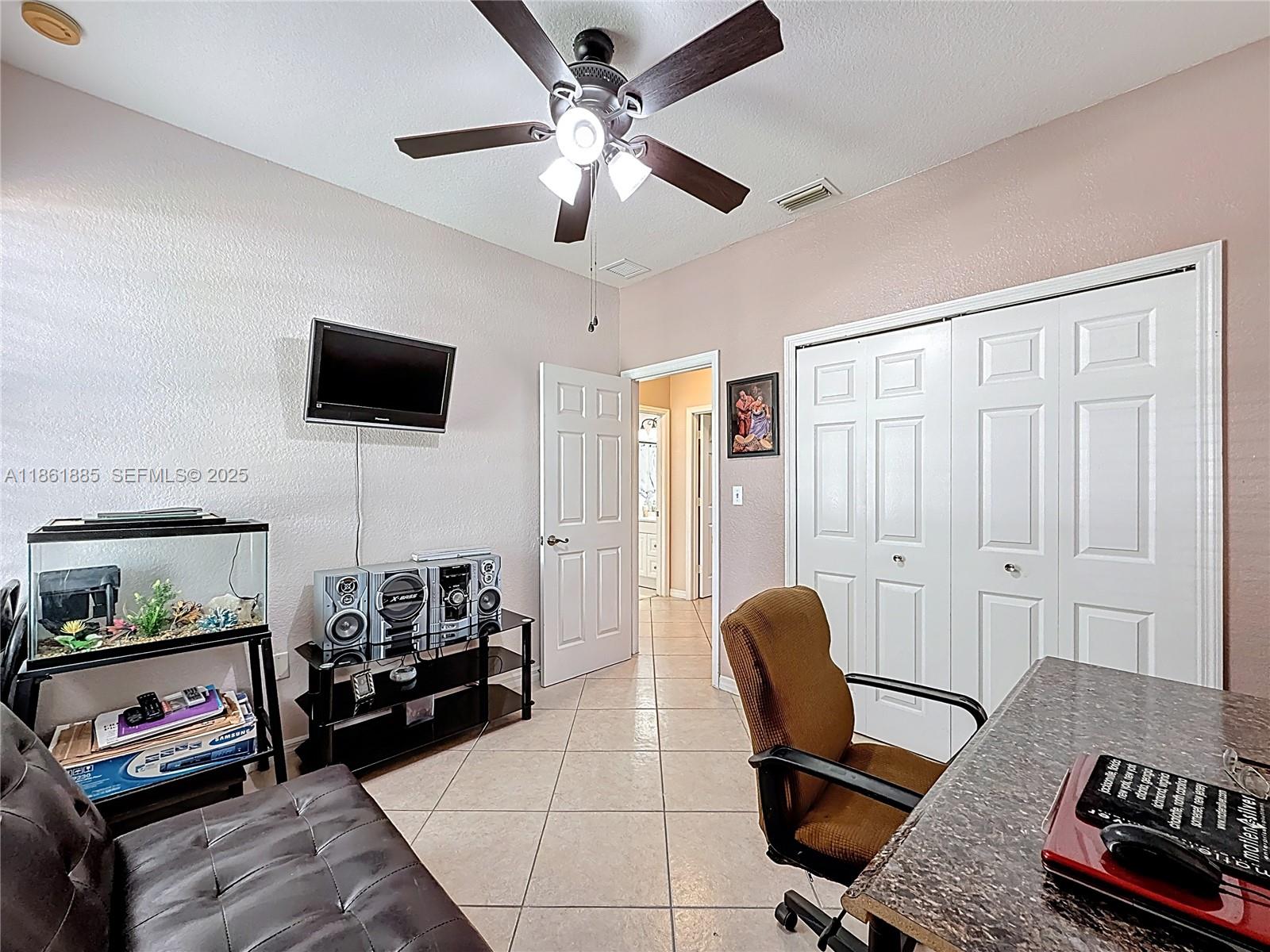 30030 Southwest 154th Avenue Homestead, FL 33033 - Photo 39 of 70 a living room with furniture and a flat screen tv