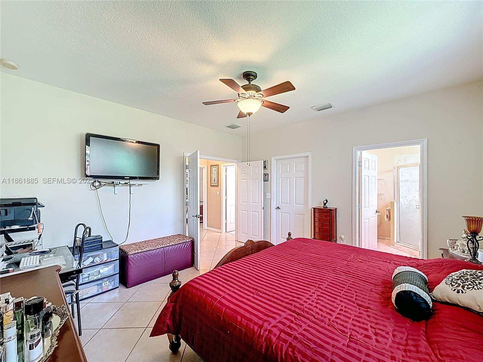 30030 Southwest 154th Avenue Homestead, FL 33033 - Photo 40 of 70 a bedroom with a bed and a flat screen tv