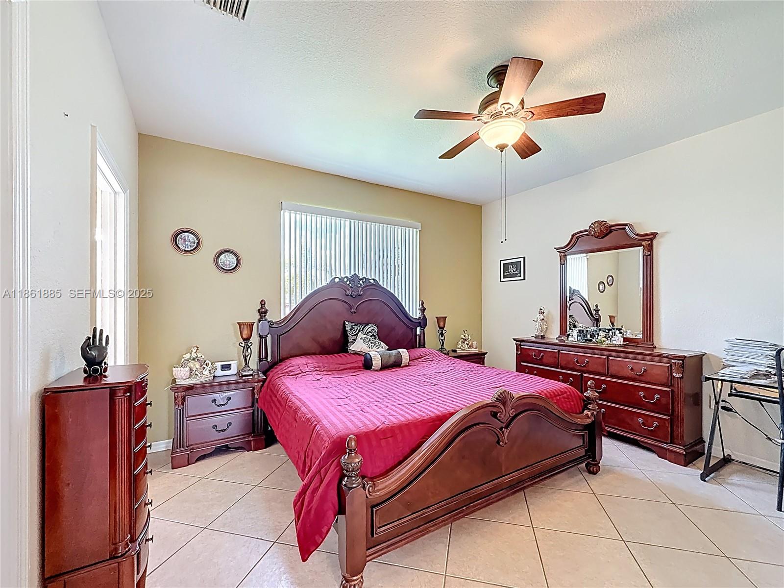 30030 Southwest 154th Avenue Homestead, FL 33033 - Photo 42 of 70 a bedroom with a bed and dresser with mirror