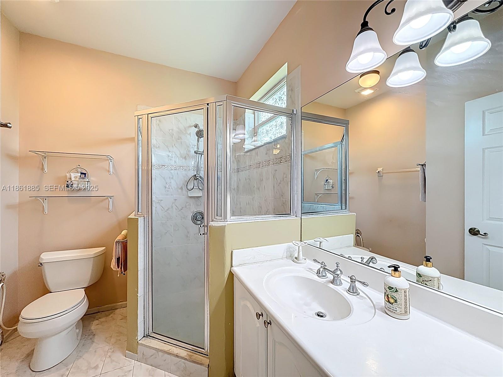 30030 Southwest 154th Avenue Homestead, FL 33033 - Photo 44 of 70 a bathroom with a sink a toilet and shower