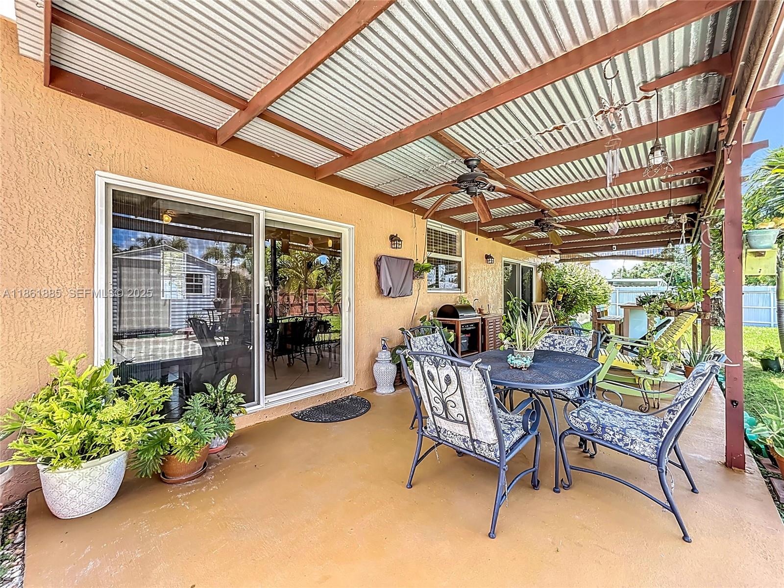 30030 Southwest 154th Avenue Homestead, FL 33033 - Photo 48 of 70 a view of a porch with furniture and a potted plant