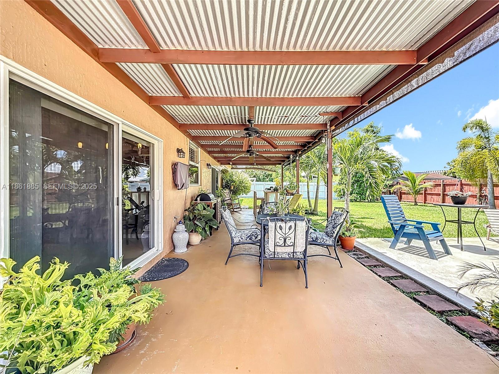 30030 Southwest 154th Avenue Homestead, FL 33033 - Photo 49 of 70 a roof deck with table and chairs potted plants with wooden floor