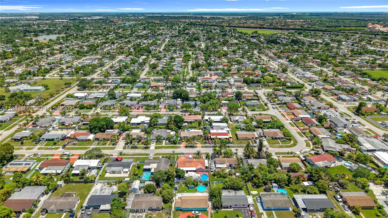 30030 Southwest 154th Avenue Homestead, FL 33033 - Photo 66 of 70 an aerial view of residential houses with outdoor space and trees