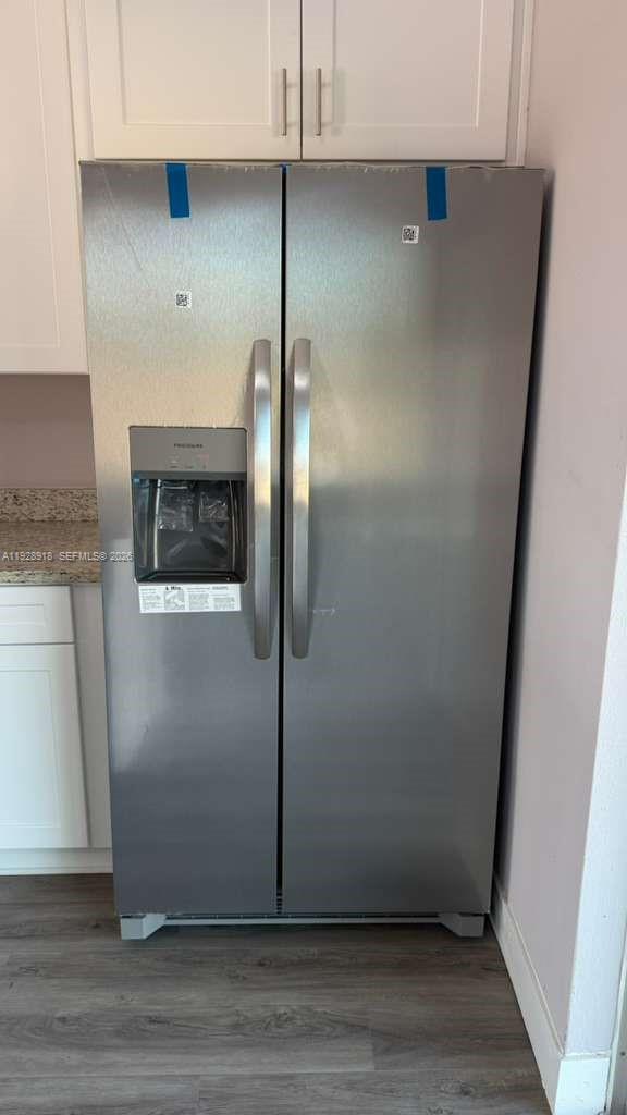 6805 Heavitree Drive Sebring, FL 33876 - Photo 12 of 61 an empty room with wooden floor and cabinets
