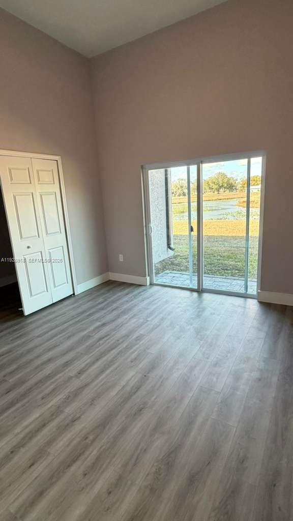 6805 Heavitree Drive Sebring, FL 33876 - Photo 22 of 61 a view of an empty room with wooden floor and a window