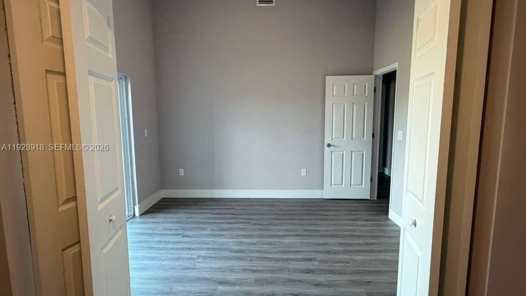 6805 Heavitree Drive Sebring, FL 33876 - Photo 23 of 61 a view of a hallway with wooden floor