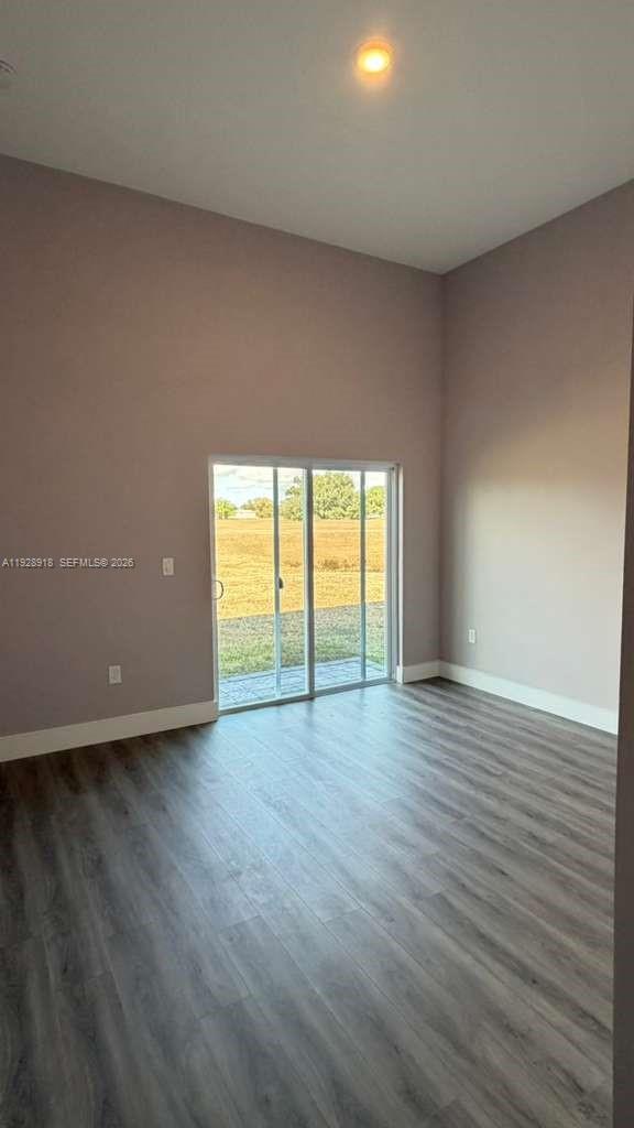 6805 Heavitree Drive Sebring, FL 33876 - Photo 29 of 61 an empty room with wooden floor and windows