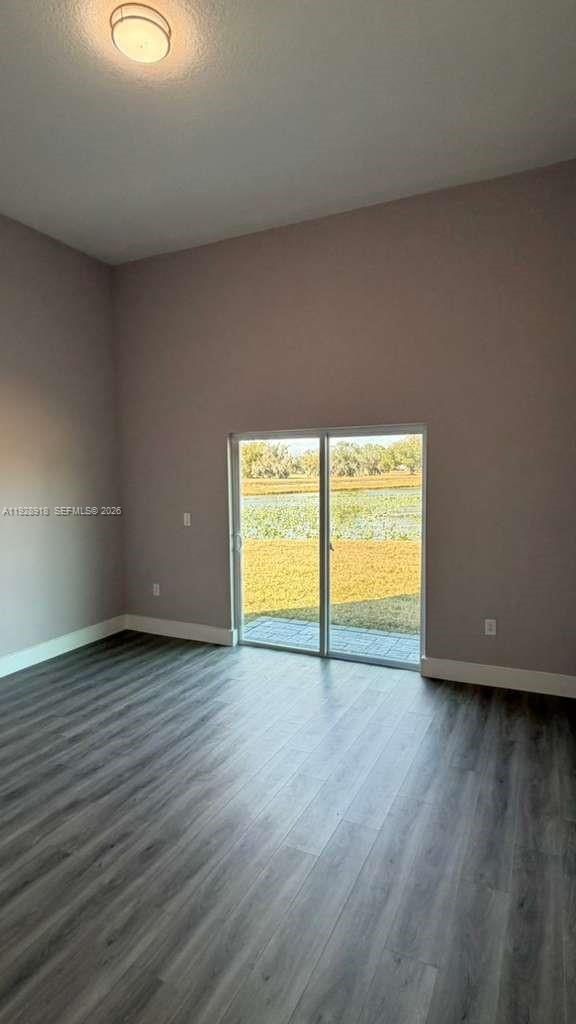 6805 Heavitree Drive Sebring, FL 33876 - Photo 46 of 61 a view of an empty room with wooden floor and a window