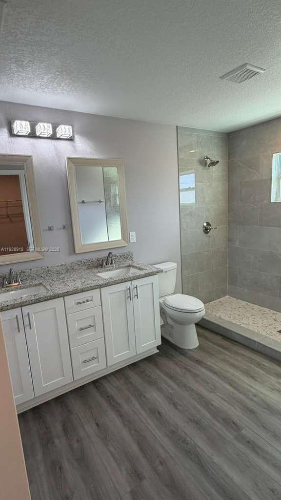 6805 Heavitree Drive Sebring, FL 33876 - Photo 47 of 61 a spacious bathroom with a granite countertop sink a toilet and a mirror