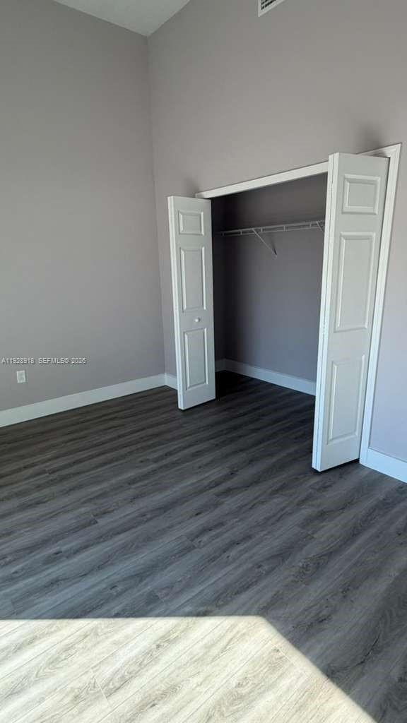 6805 Heavitree Drive Sebring, FL 33876 - Photo 53 of 61 a view of an empty room with wooden floor and closet