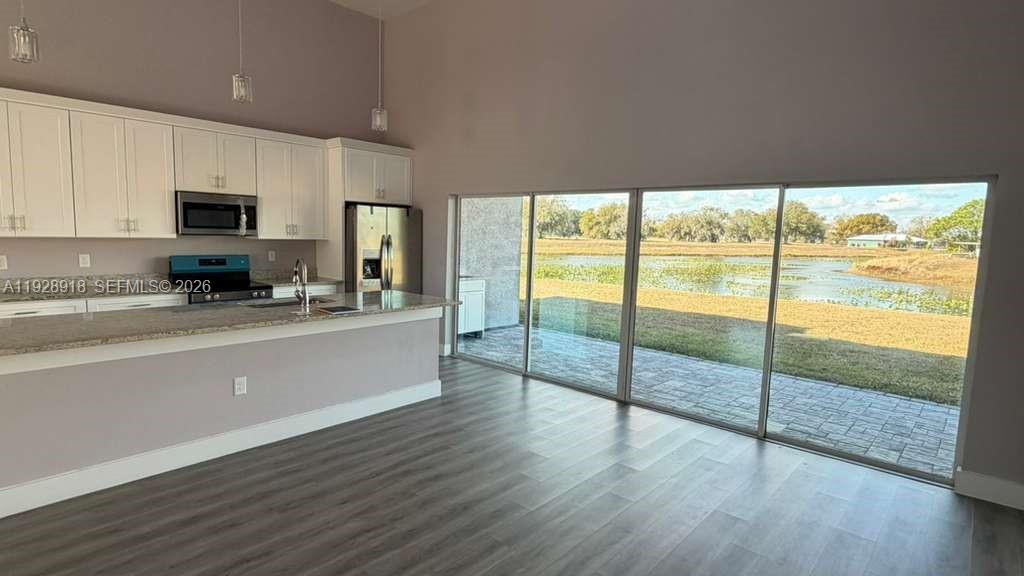 6805 Heavitree Drive Sebring, FL 33876 - Photo 6 of 61 a kitchen with counter top space and stainless steel appliances