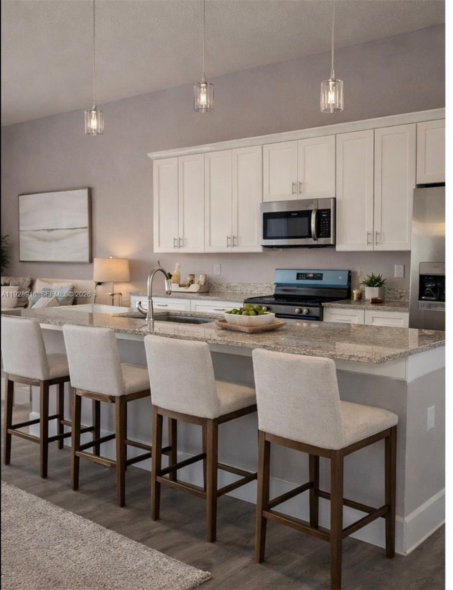 6805 Heavitree Drive Sebring, FL 33876 - Photo 8 of 61 a kitchen with a dining table chairs and a sink