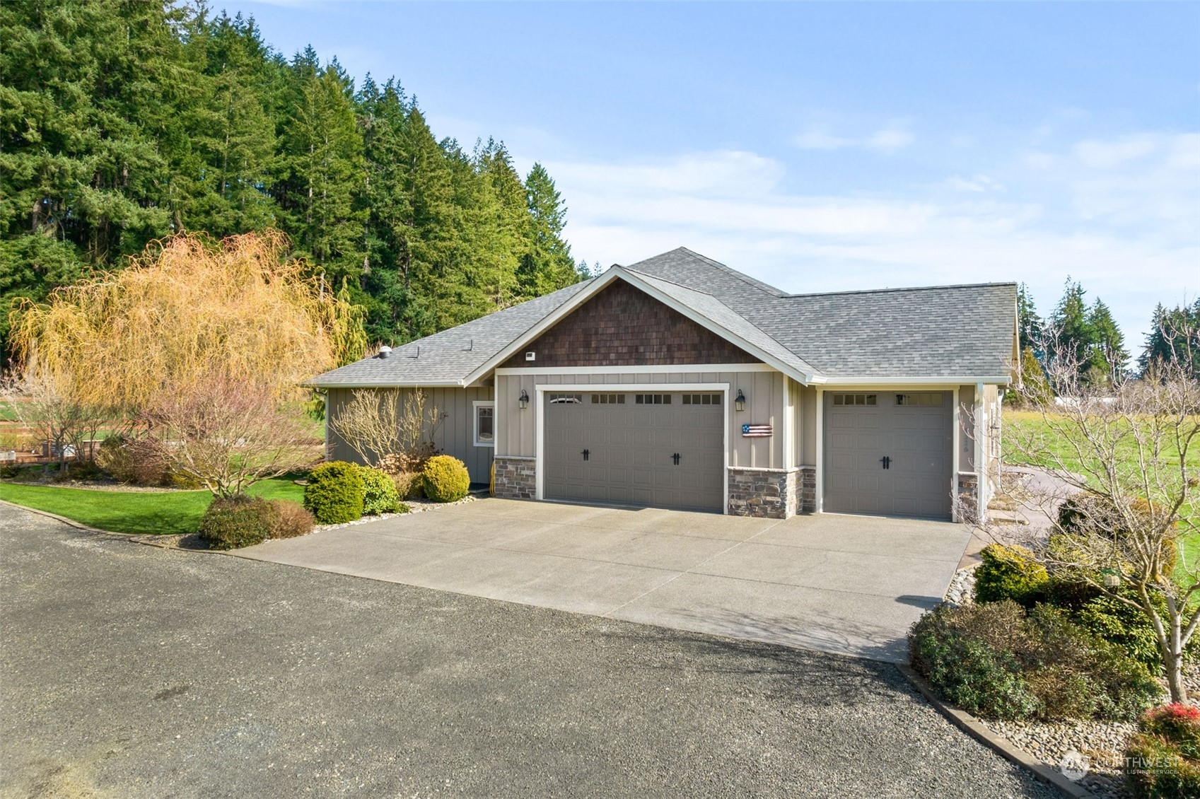 9336 James Road Southwest Rochester, WA 98579 - Photo 6 of 40 a front view of a house with a yard and garage