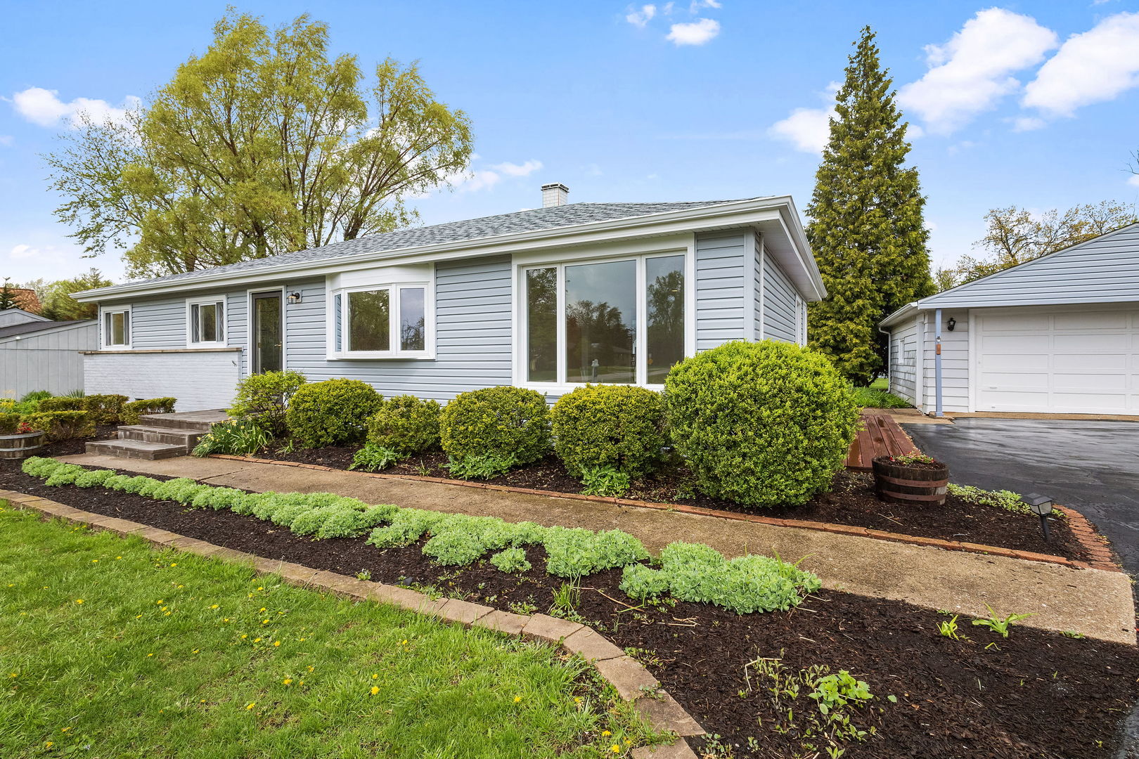 646 68th Street Willowbrook, IL 60527 - Photo 25 of 27 a front view of a house with a yard and potted plants