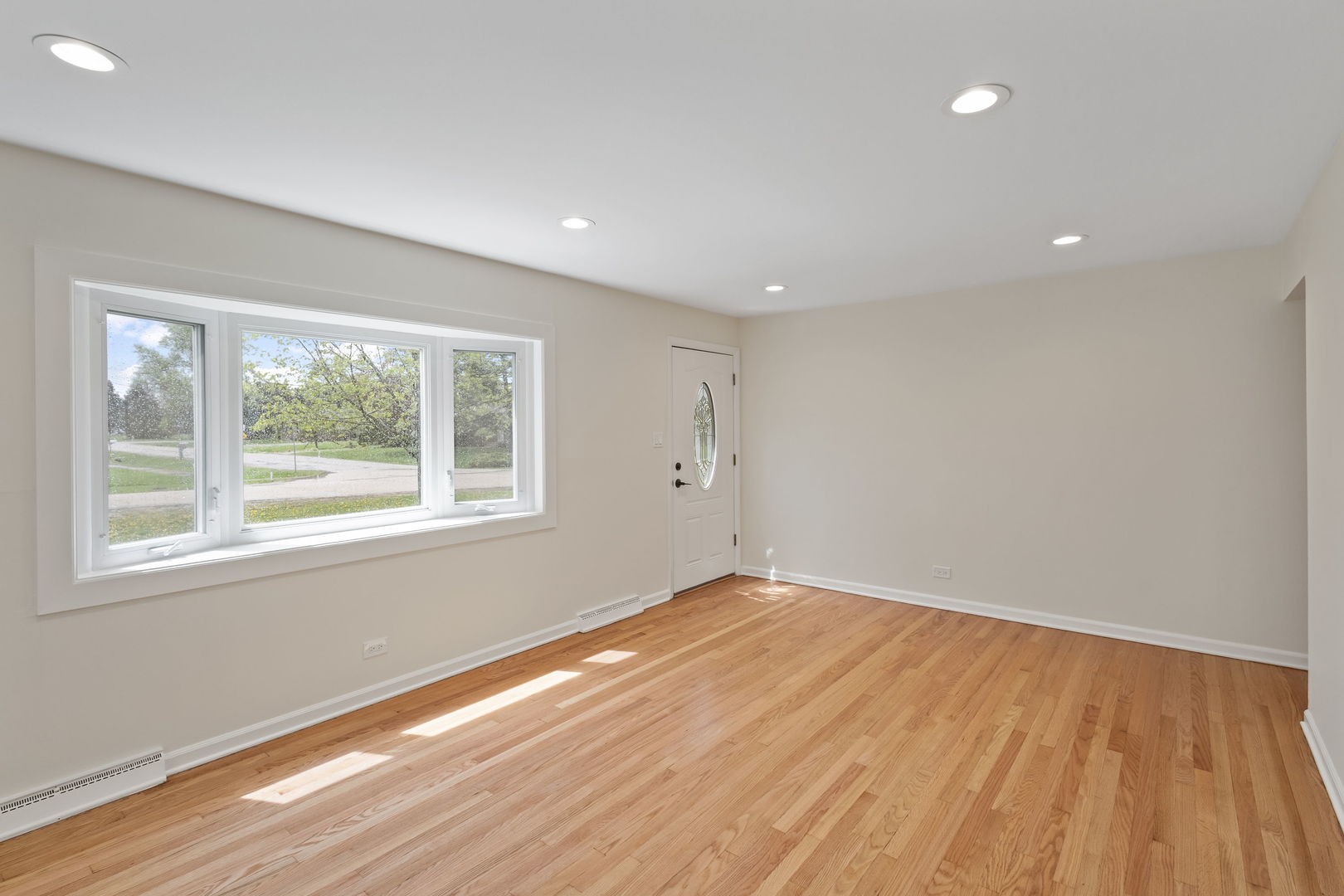 646 68th Street Willowbrook, IL 60527 - Photo 3 of 27 a view of empty room with wooden floor and fan
