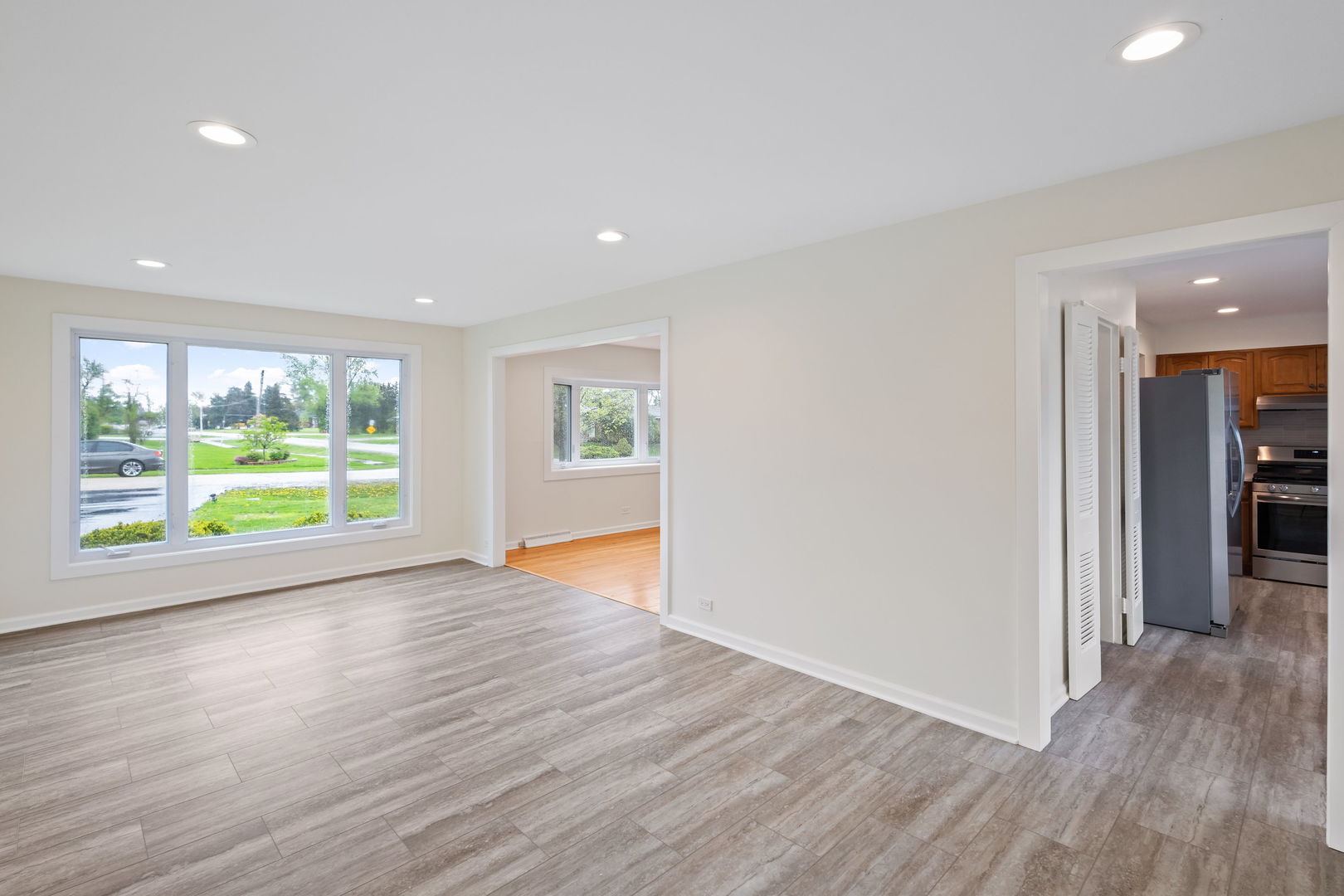 646 68th Street Willowbrook, IL 60527 - Photo 7 of 27 a view of an empty room with wooden floor and a window