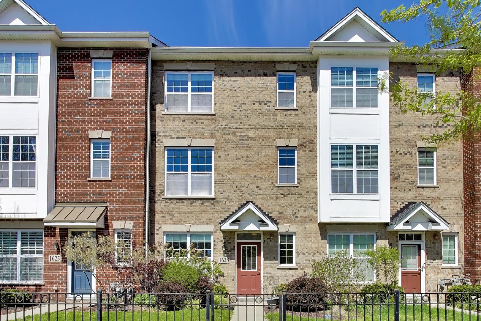 1623 Church Street Evanston, IL 60201 - Photo 1 of 29 a front view of a residential apartment building with a yard