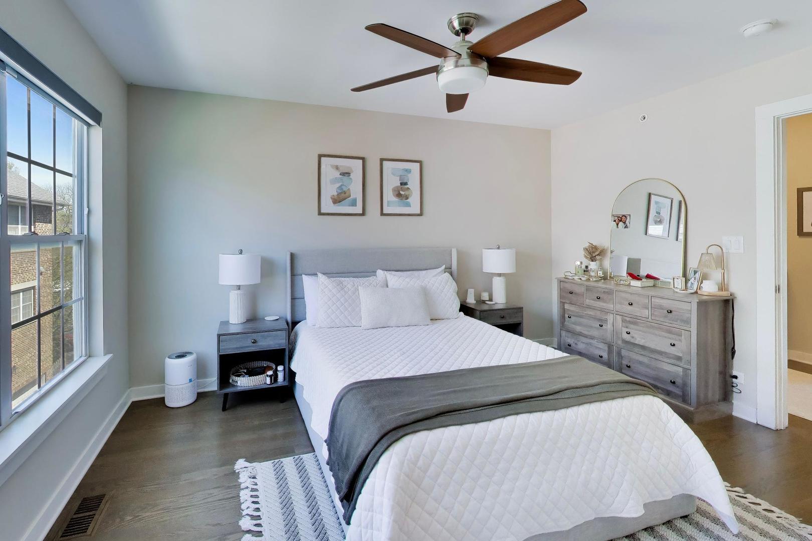 1623 Church Street Evanston, IL 60201 - Photo 15 of 29 a bedroom with a bed and a chandelier