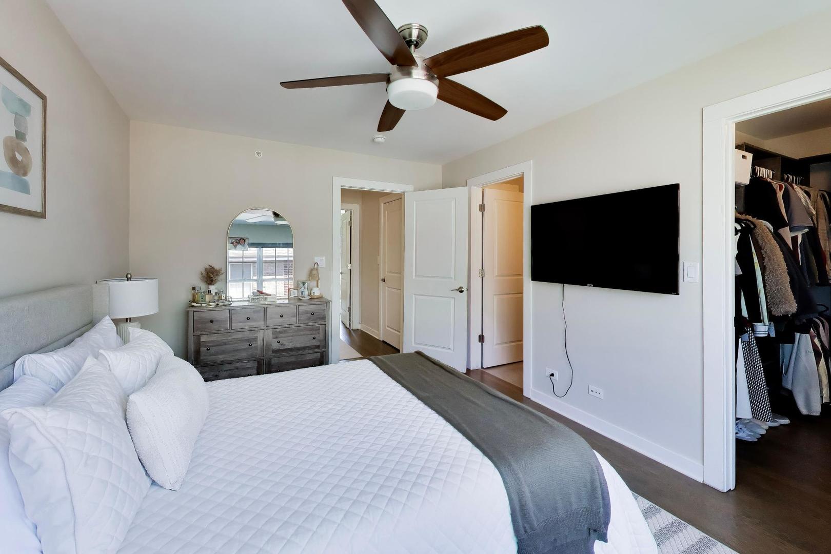 1623 Church Street Evanston, IL 60201 - Photo 16 of 29 a bedroom with a bed a tv and wooden floor