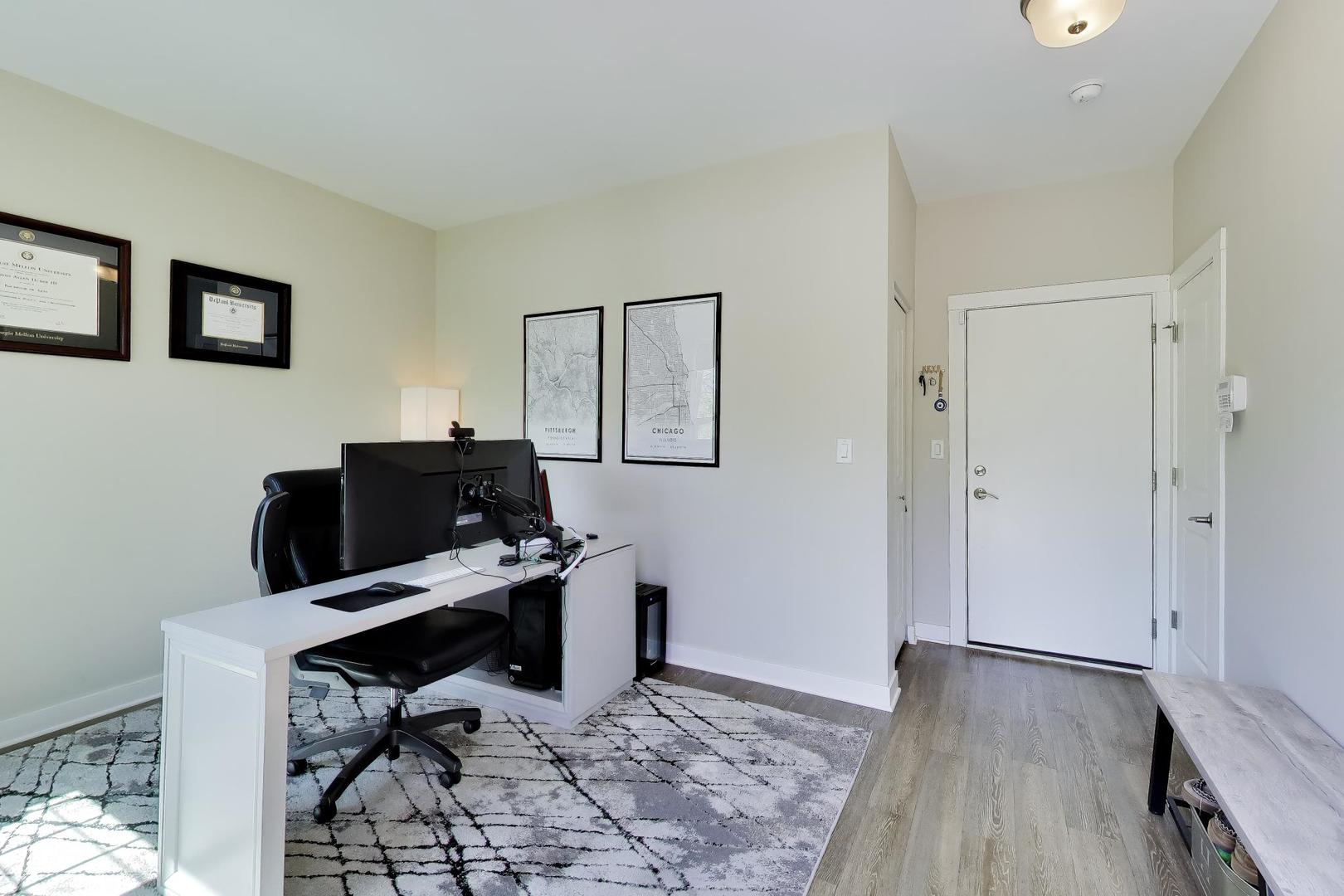 1623 Church Street Evanston, IL 60201 - Photo 3 of 29 a view of a workspace with furniture and wooden floor