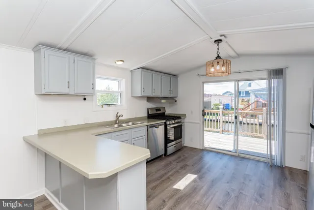 a kitchen with wooden floors and appliances