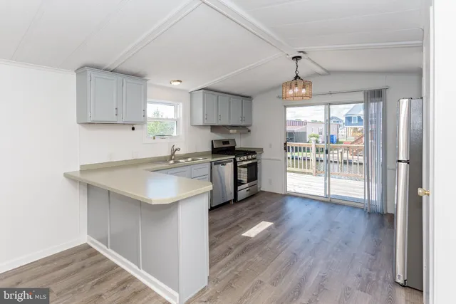 a view of a dining room with furniture wooden floor and chandelier