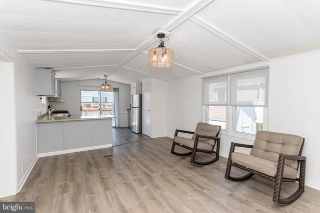 a view of a livingroom with lounge chair and a window