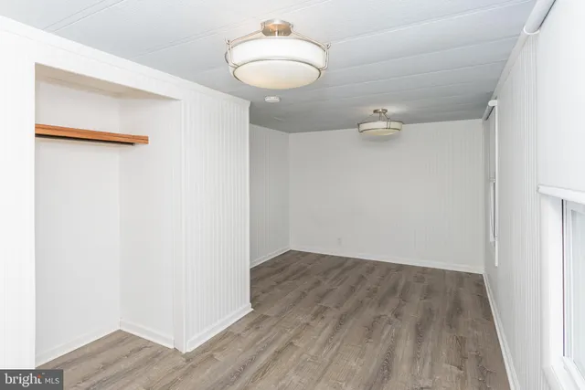a view of backyard with deck and wooden floor