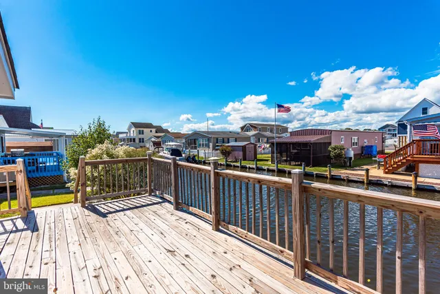 a kitchen with stainless steel appliances granite countertop a refrigerator a stove a sink and a window