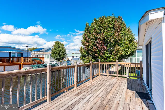 a kitchen with granite countertop a stove a sink a center island and wooden floor
