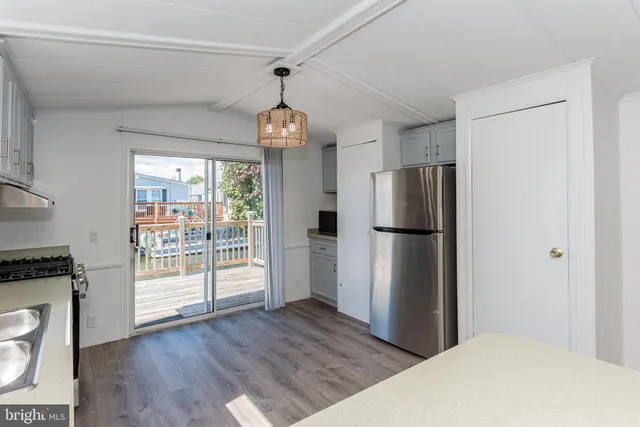 a kitchen with stainless steel appliances granite countertop a sink a stove and a refrigerator